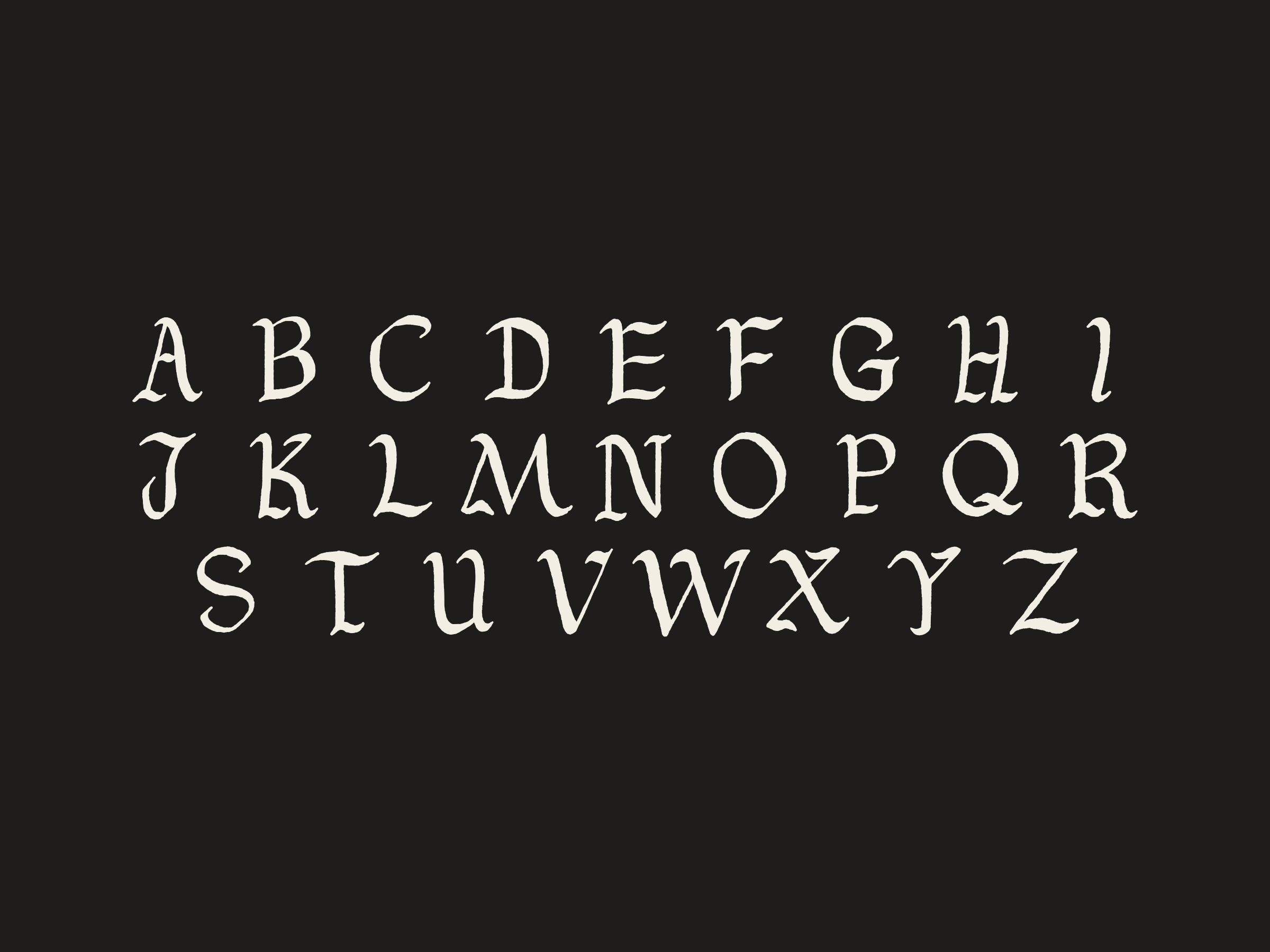 The capitals A to Z in three rows, cream on near-black.
