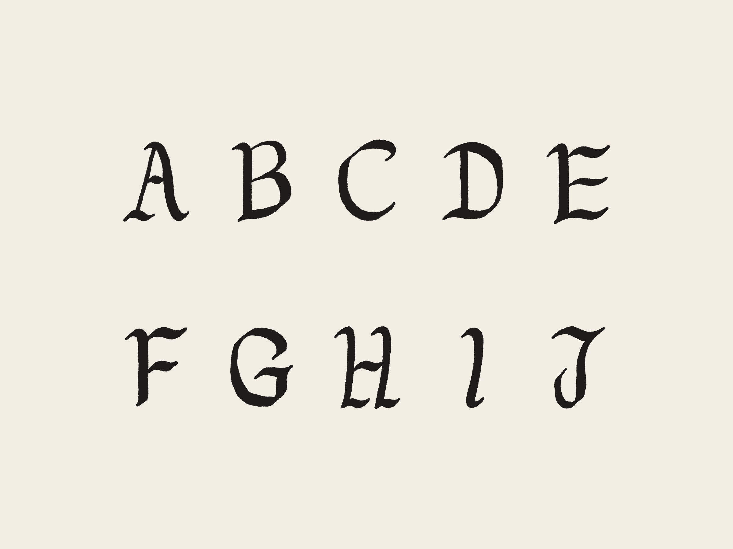 The original hand-drawn capitals A to J in two rows, black on cream.